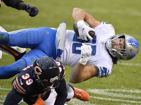 T.J. Hockenson of the Detroit Lions is tackled by Eddie Jackson of the Chicago Bears during the second half at Soldier Field on December 06, 2020 in Chicago, Illinois.