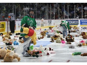 In this file photo from Dec. 14, 2008, a young volunteer helps pick up teddy bears from the ice surface at the WFCU Centre during a Windsor Spitfires game. The team held their annual teddy bear toss for charity.