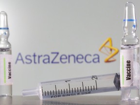 A test tube labelled with the Vaccine is seen in front of AstraZeneca logo in this illustration taken, Sept. 9, 2020.