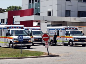 During the first wave of the novel coronavirus, Essex-Windsor EMS ambulances are shown lined up outside Erie Shores HealthCare in Leamington on July 2, 2020.