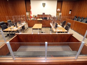 The prisoner's box in the foreground is shown Thursday surrounded by Plexiglass in one of the courtrooms at the Superior Court of Justice in Windsor. Plexiglass also surrounds the judge's bench, the tables for Crown and defence lawyers, as well as court clerk and court reporter and witness stand.