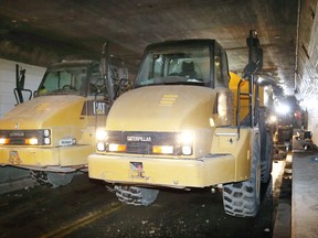 Two massive Caterpillar haulers were positioned in front of an active construction site where about 48,000 square feet of concrete from the roof of the Detroit Windsor Tunnel is being removed and replaced, in this file photo from October 2017.