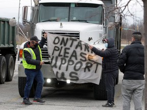 Dump truck owners participate in a protest convoy in Windsor on Dec. 28, 2020.