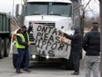 Dump truck owners participate in a protest convoy in Windsor on Dec. 28, 2020.
