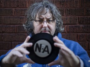 Windsor filmmaker Otto Buj holds an original 7-inch single by Detroit hardcore punk band Negative Approach, circa 1982. Buj's new documentary is titled Dope, Hookers and Pavement: The Real and Imagined History of Detroit Hardcore.