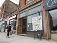 A closed store front boutique business called Francis Watson pleads for help displaying a sign in Toronto on Thursday, April 16, 2020.