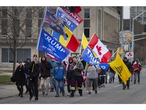 Approximately 30 demonstrators march down Ouellette Avenue protesting what they call harmful and unnecessary measures to combat COVID-19, Sunday, Dec. 6, 2020.