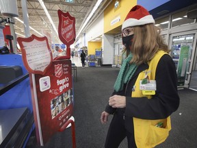 Patricia Sarson, a greeter at the Walmart location on Dougall Avenue in South Windsor, looks at the Salvation Army's Christmas kettle equipped with tiptap technology on Dec. 9, 2020.