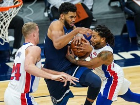 Timberwolves center Karl-Anthony Towns drives past Detroit Pistons forward Mason Plumlee and guard Derrick Rose during the fourth quarter at Target Center.