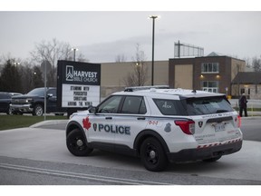 Windsor Police monitor Harvest Bible Church where a drive-in service for Christmas Eve was held, Thursday, Dec. 24, 2020.