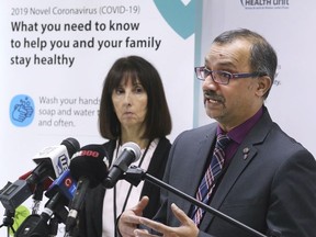 Dr. Wajid Ahmed speaks at a news conference in March 2020 while CEO Theresa Marentette looks on.