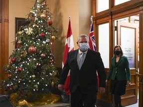 Ontario Premier Doug Ford and Ontario Health Minister Christine Elliott leave the premiers office before holding a press conference at Queen's Park during the COVID-19 pandemic in Toronto on Monday, December 21, 2020.
