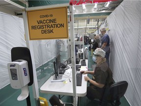 On the first day of local inoculations, the Covid-19 vaccine registration desk at the St. Clair College SportsPlex field hospital is shown on Tuesday, Dec. 22, 2020.