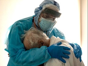 HOUSTON, TX - NOVEMBER 26: (EDITORIAL USE ONLY) Dr. Joseph Varon hugs and comforts a patient in the COVID-19 intensive care unit (ICU) during Thanksgiving at the United Memorial Medical Center on November 26, 2020 in Houston, Texas. According to reports, Texas has reached over 1,220,000 cases, including over 21,500 deaths. (Photo by Go Nakamura/Getty Images)