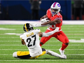Buffalo Bills running back Zack Moss avoids the tackle attempt of Pittsburgh Steelers safety Marcus Allen during the fourth quarter at Bills Stadium.