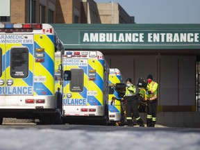 WINDSOR, ONT:. DECEMBER 18, 2020 - EMS workers work outside the ambulance entrance at Windsor Regional Hospital - Met Campus, Friday, Dec. 18, 2020.