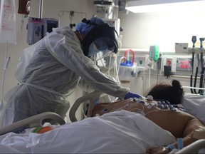 A medical staff member treats a patient suffering from the coronavirus disease in the intensive care unit, at Scripps Mercy Hospital in Chula Vista, Calif., May 12, 2020.
