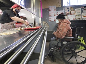 Dan Ouellette receives a Christmas meal at the Downtown Mission in Windsor, ON. on December 25, 2020.