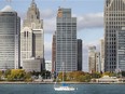 A sailboat is shown cruising past downtown Detroit and a portion of the Detroit Riverwalk on Oct. 21, 2020.