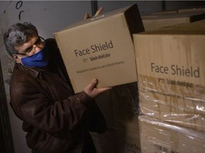 Windsor West Tory riding association president Tony Francis helps unload thousands of donated face shields at Windsor Regional Hospital's Met campus, Wednesday, Dec. 30, 2020.