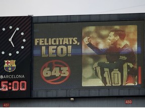 Big screen showing Barcelona's Lionel Messi scoring 643 goals equaling Pele's record for most goals at one club .