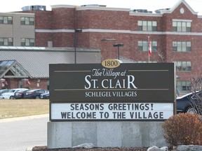 A sign at the entrance of The Village at St. Clair, a long-term care facility under Schlegel Villages, located in Windsor. Photographed Dec. 15, 2020.