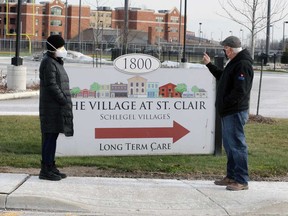 Tullio DiPonti (right) of Unifor Local 2458 speaks with Gisele Harrison (left), whose mother is a resident of The Village at St. Clair, outside the Windsor long-term care home on Dec. 29, 2020.