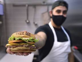 Adam El-Dika operator of WhamBurg displays one of his signature burgers on Thursday, November 26, 2020 on the campus of the University of Windsor.