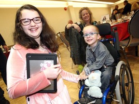 2020 Windsor-Essex Regional Ambassadors Brigid Kidd, left, and Alex Bondy have some fun while posing for photos during Easter Seals Breakfast Kickoff event held at Giovanni Caboto Club of Windsor.