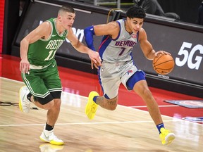 Killian Hayes of the Detroit Pistons drives to the basket against Payton Pritchard of the Boston Celtics during the first half at Little Caesars Arena on January 01, 2021 in Detroit, Michigan.