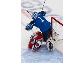 EDMONTON, AB - JANUARY 05: Vasili Ponomaryov #13 of Russia crashes into goaltender Kari Piiroinen #1 of Finland during the 2021 IIHF World Junior Championship bronze medal game at Rogers Place on January 5, 2021 in Edmonton, Canada.