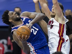 Joel Embiid of the Philadelphia 76ers controls the ball against Kelly Olynyk of the Miami Heat in overtime at the Wells Fargo Center on January 12, 2021 in Philadelphia, Pennsylvania. The 76ers defeated the Heat 137-134.