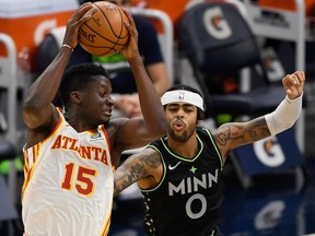 Clint Capela of the Atlanta Hawks catches a pass intended for D'Angelo Russell of the Minnesota Timberwolves during the second quarter of the game at Target Center on January 22, 2021 in Minneapolis, Minnesota.
