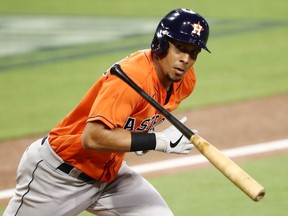 Michael Brantley of the Houston Astros throws his bat while looking at the Tampa Bay Rays dugout while running on a fly out during the third inning in Game Seven of the American League Championship Series at PETCO Park on Oct. 17, 2020 in San Diego, California.