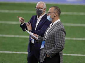 Detroit Lions president and CEO Rod Wood speaks with Chris Spielman prior to a game at Ford Field.