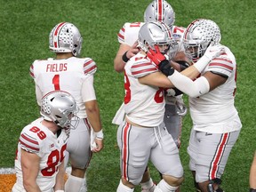 NEW ORLEANS, LOUISIANA - JANUARY 01: Luke Farrell #89. Jeremy Ruckert #88, Justin Fields #1 and Max Wray #74 of the Ohio State Buckeyes celebrate a touchdown against the Clemson Tigers in the first half during the College Football Playoff semifinal game at the Allstate Sugar Bowl at Mercedes-Benz Superdome on January 01, 2021 in New Orleans, Louisiana.
