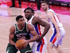 Giannis Antetokounmpo of the Milwaukee Bucks drives against Isaiah Stewart of the Detroit Pistons in the third quarter of the game at Little Caesars Arena on January 13, 2021 in Detroit, Michigan.