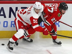 Valtteri Filppula of the Detroit Red Wings is called for holding Adam Boqvist of the Chicago Blackhawks at the United Center on January 22, 2021 in Chicago, Illinois.