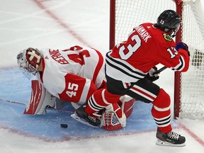 Jonathan Bernier of the Detroit Red Wings makes a stop on a shot by Mattias Janmark of the Chicago Blackhawks at the United Center on January 24, 2021 in Chicago, Illinois.