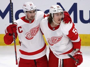 Tyler Bertuzzi of the Detroit Red Wings (R) gets a hug from Dylan Larkin after scoring a third period goal against the Chicago Blackhawks at the United Center on January 24, 2021 in Chicago, Illinois. The Blackhawks defeated the Red Wings 6-2.