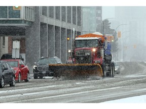Windsor, Ontario. January 24, 2021. Salters and snowplows hit the street in Windsor, Sunday afternoon. In photo, a contractor snowplow rumbles along Riverside Drive West at Ferry Street. (NICK BRANCACCIO/Windsor Star)