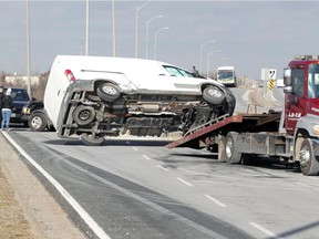 Essex-Windsor EMS paramedics, Windsor police and A.M-P.M. Towing responded to the scene of a two-vehicle collision involving a Ford F-150 pickup truck and a Ford Transit 250 cargo van on the EC Row Expressway exit ramp to southbound Lauzon Parkway on Thursday, Jan. 21, 2021.  Southbound traffic on Lauzon Parkway was slowed for over a hour as the incident was investigated and debris cleared from the roadway.
