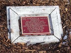 A plaque lies next to a memorial bench and tree at Little River Corridor Park near the location  on the Ganatchio Trail where Sara Anne Widholm was attacked.