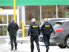 With clipboards in hand, provincial Ministry of Transportation officers attended the Food Basics location on Goyeau Avenue in downtown Windsor Sunday afternoon at 2:30 p.m.  (NICK BRANCACCIO/Windsor Star)