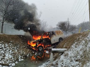 Citizens pulled the driver from this van after it crashed into a ditch and caught fire in Kingsville on Sunday, Jan. 24, 2021.