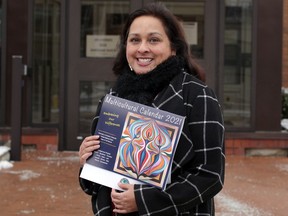 Rachel Olvero, diversity officer for  the Greater Essex County District School Board, is photographed with the board's Multicultural 2021 Calendar on Park Street West Tuesday.