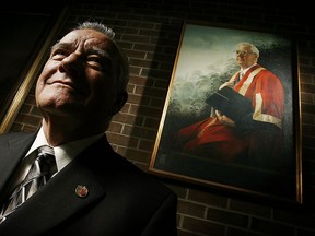 In this Nov. 20, 2005, photo, George McMahon poses in front of a portrait of the late Dr. Frank Leddy in the lobby of the library that bears the former University of Windsor president's name. McMahon was at the launch of a book stemming from his discovery of a collection of letters he found after taking over Leddy's office.