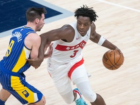 Raptors' OG Anunoby (right) dribbles the ball while Indiana Pacers' T.J. McConnell defends during the fourth quarter at Bankers Life Fieldhouse on Sunday, Jan. 24, 2021.