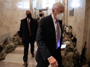 House Majority Leader Steny Hoyer, Democrat of Maryland, walks past members of the National Guard as he arrives at the U.S. Capitol in Washington, D.C., Wednesday, Jan. 13, 2021, ahead of an expected House vote impeaching President Donald Trump.