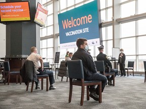 People wait for 15 minutes after receiving their COVID-19 vaccine at Gillette Stadium on January 15, 2021 in Foxborough, Massachusetts.